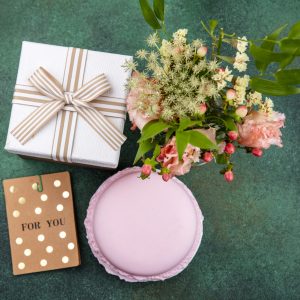 top view of beautiful and lovely flowers with leaves on green background